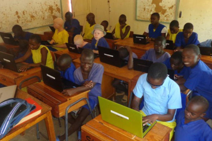 picture of Kenya St. Oda Students diligently doing homework aided by assistive technology